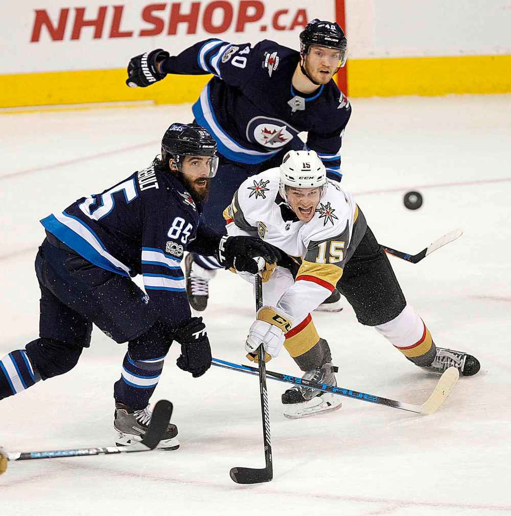 PHIL HOSSACK / WINNIPEG FREE PRESS
Winnipeg Jets' Mathieu Perreault and Joel Armia watch as Vegas Golden Knights' Jon Merrill clears the puck out of the Knight's zone, Friday.