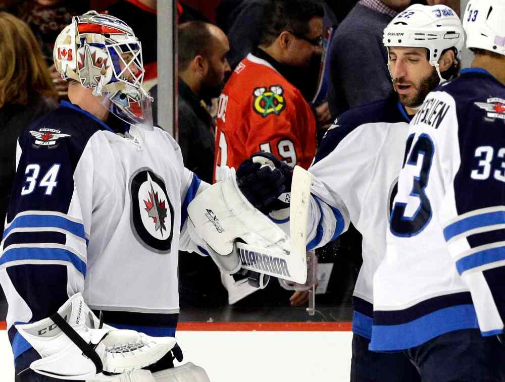 Nam Y. Huh / Associated Press files
Michael Hutchinson celebrates with right wing Chris Thorburn after the Winnipeg Jets defeated the Chicago Blackhawks 1-0 on Sunday.
