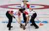 Wong Maye-E / The Associated Press
Canada's Brad Jacobs, back, watches as Ryan Harnden, left, and E.J. Harnden, right, sweep during Canada's match against the United States.