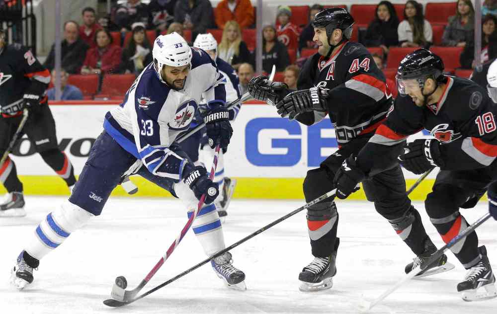 Gerry Broome / Associated Press files
Dustin Byfuglien may have a new linemate in Carolina Hurricanes' Jay Harrison (44).