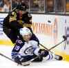 Winslow Townson / The Associated Press
Boston Bruins defenceman Matt Bartkowski dumps Winnipeg Jets' Jim Slater (19) during the third period.