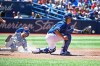 Kansas City Royals' Whit Merrifield, left, slides home ahead of the tag by Toronto Blue Jays catcher Luke Maile during third inning MLB baseball action in Toronto on Sunday, June 30, 2019. THE CANADIAN PRESS/Jon Blacker