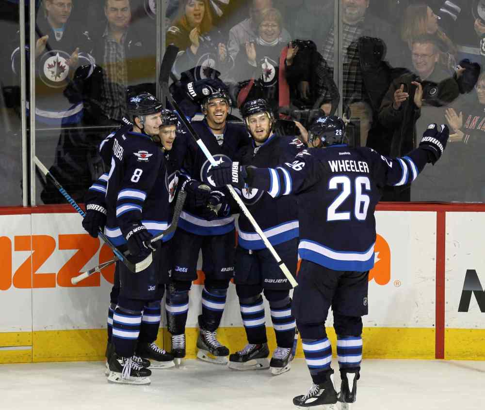 Phil Hossack / Winnipeg Free Press
Jets' Blake Wheeler skates in to congratulate teammate Evander Kane for scoring the tying goal against the Boston Bruins Thursday at the MTS centre.