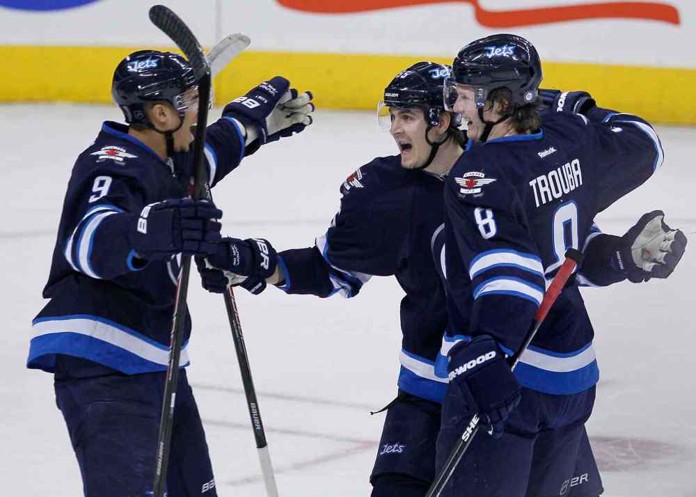 John Woods / The Canadian Press
Evander Kane (left), Mark Scheifele (centre) and Jacob Trouba celebrate Trouba's goal against the Florida Panthers during the first period of Friday's 5-2 win.