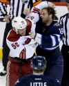 Trevor Hagan / The Canadian Press
Coyotes Derek Morris fights Jets captain Andrew Ladd.