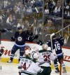 Trevor Hagan / The Canadian Press
Winnipeg Jets' Bryan Little (18) and Andrew Ladd (16)  celebrate after Little scored on Minnesota Wild goaltender Darcy Kuemper (35) during the first period.