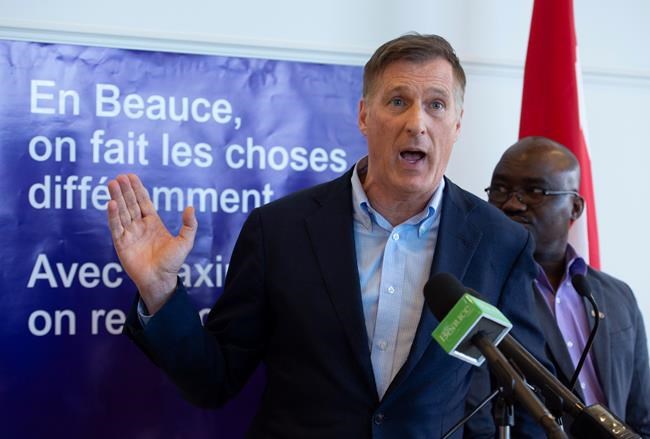People's Party of Canada Leader Maxime Bernier speaks at a news conference on Saturday, October 19, 2019 in Sainte-Marie Que. PPC candidate in Quebec Bruno Dabire, right, looks on. Bernier reacted to reports linking the Conservative party to a co-ordinated effort to smear him and his nascent populist People's Party of Canada.THE CANADIAN PRESS/Jacques Boissinot