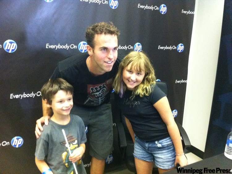 Tyler Walsh / Winnipeg Free Press
Winnipeg Jets’ captain Andrew Ladd poses with some of the city’s hockey-crazed fans Friday afternoon.