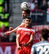 Bayern's Mats Hummels, up, and Duesseldorf's Aymen Barkok challenge for the ball during the German Bundesliga soccer match between Fortuna Duesseldorf and Bayern Munich in Duesseldorf, Germany, Sunday April 14, 2019. (AP Photo/Martin Meissner)