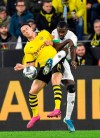 Moenchengladbach's Marcus Thuram, right, and Dortmund's Nico Schulz challenge for the ball during the German Bundesliga soccer match between Borussia Dortmund and Borussia Moenchengladbach in Dortmund, Germany, Saturday Oct. 19, 2019. (AP Photo/Martin Meissner)