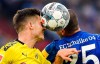 Dortmund's Julian Weigl, left, and Schalke's Amine Harit challenge for the ball during the German Bundesliga derby soccer match between FC Schalke 04 and Borussia Dortmund in Gelsenkirchen, Germany, Saturday Oct. 26, 2019. (AP Photo/Martin Meissner)