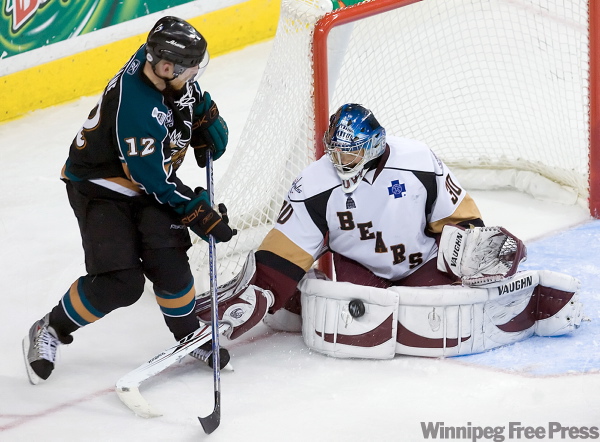 SEAN SIMMERS / The Patriot-News
Hershey Bears goalie Michal Neuvirth stops Manitoba Moose Mike Keane during the Moose 3-2 win in game 5 of the Calder Cup finals at Giant Center in Hershey. Game 6 is in Winnipeg Friday.