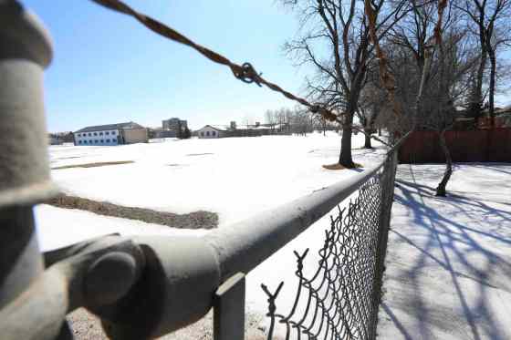 RUTH BONNEVILLE / WINNIPEG FREE PRESSThe view from Grant Avenue, looking southward through the fence of Kapyong Barracks with a row of residential homes on far left side.