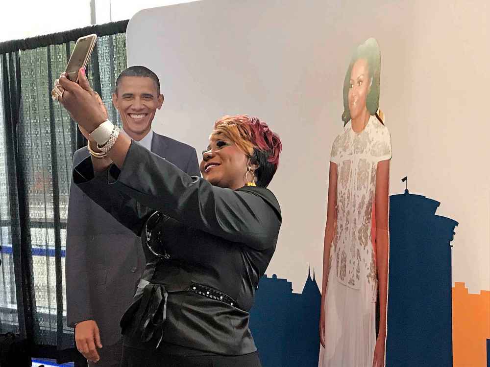JESSICA BOTELHO-URBANSKI/WINNIPEG FREE PRESS
Justina Stone poses with cardboard cutouts of Barack and Michelle Obama in the lobby at Bell MTS Place Tuesday.
