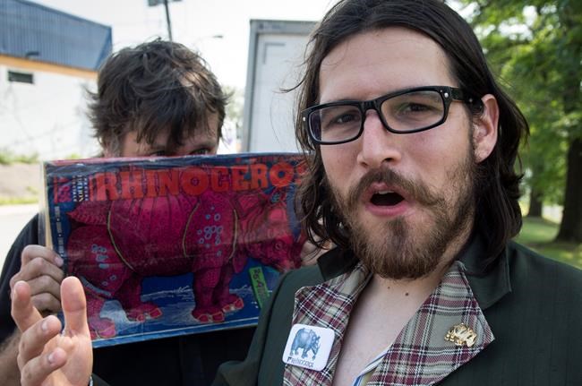 Rhinoceros Party Leader Sebastien CoRhino Corriveau, right, and candidate Ben 97 Benoit talk with reporters Monday, August 17, 2015 in Montreal. The satirical political party promised to nationalize the popular Tim Hortons coffee shops if elected in the next federal election. THE CANADIAN PRESS/Paul Chiasson