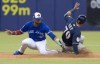 Milwaukee Brewers' Nate Orf steals second base ahead of the tag by Toronto Blue Jays second baseman Lourdes Gurriel Jr. during fifth inning of a spring training baseball game in Montreal on Tuesday, March 26, 2019. THE CANADIAN PRESS/Paul Chiasson