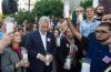 A demonstrator, right, raises a candle next to Quebec Premier Philippe Couillard moments before lunging on the Premier during a vigil for the victims of the shooting in Orando Thursday, June 16, 2016 in Montreal. THE CANADIAN PRESS/Paul Chiasson