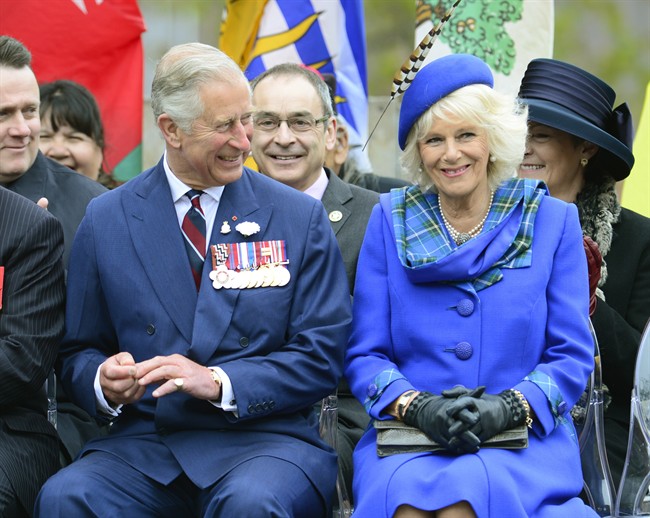 Prince Charles and his wife Camilla smile during an event in Halifax on Monday, May 19, 2014. THE CANADIAN PRESS/Paul Chiasson