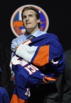 Bill Kostroun / The Associated Press
Grandview's Ryan Pulock pulls on a New York Islanders sweater after being chosen 15th overall in the first round of the NHL hockey draft.