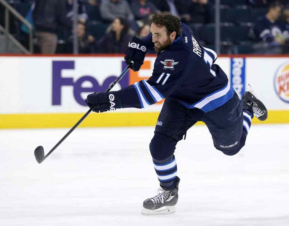 Trevor Hagan / The Canadian Press
Winnipeg Jets' Andrew Ladd fires a puck during warmup before his team plays the Nashville Predators in Winnipeg on Tuesday. The entire team wore a Rick Rypien jersey during the warmup in honour of 27-year-old Rypien, who had a long history of depression and killed himself less than two months after he signed with the Jets in 2011.