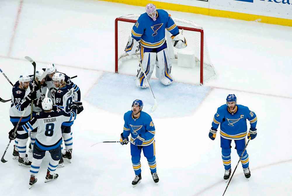 CP
Teammates surround Winnipeg Jets' Patrik Laine (29), of Finland, after he scored his fourth goal of an NHL hockey game in the second period as St. Louis Blues' Chad Johnson (31), Jordan Schmaltz (43) and Alex Pietrangelo (27) stand by Saturday, Nov. 24, 2018, in St. Louis. (AP Photo/Jeff Roberson)