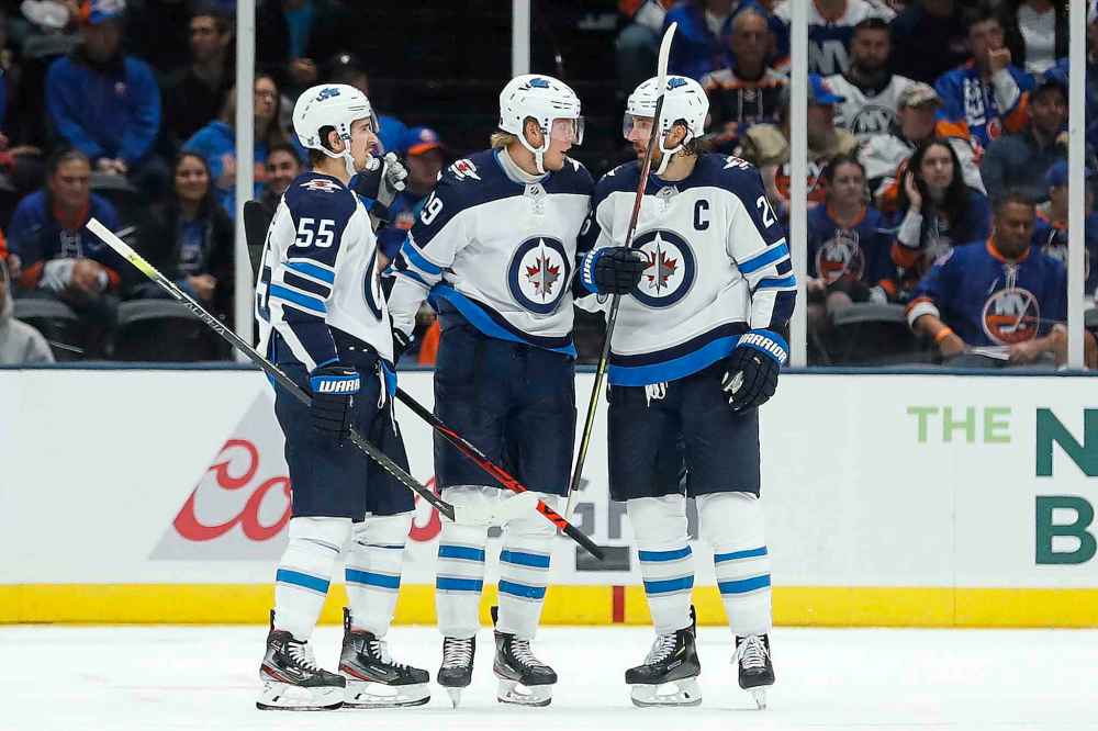 MICHAEL OWENS / THE ASSOCIATED PRESS
Winnipeg Jets right wing Patrik Laine, middle, celebrates with center Mark Scheifele (55) and right wing Blake Wheeler after scoring a goal against the New York Islanders during the second period of an NHL hockey game Sunday, Oct. 6, 2019, in Uniondale, N.Y.