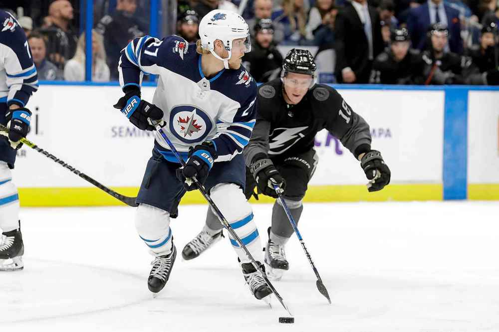 CHRIS O'MEARA / THE ASSOCIATED PRESS
Winnipeg Jets left wing Nikolaj Ehlers (27) moves the puck in front of Tampa Bay Lightning left wing Ondrej Palat (18) during the second period of an NHL hockey game Saturday, Nov. 16, 2019, in Tampa, Fla.