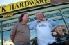 KEN GIGLIOTTI / WINNIPEG FREE PRESS
NDP leadership candidate Greg Selinger (right) tries on a Pollock's Hardware T-shirt with co-op treasurer Tom Simms outside the store Thursday morning.