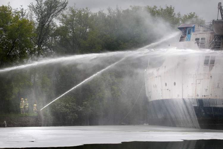 Winnipeg Free Press archives
Firefighters shoot water into the wheelhouse of the MS Lord Selkirk II on June 19.