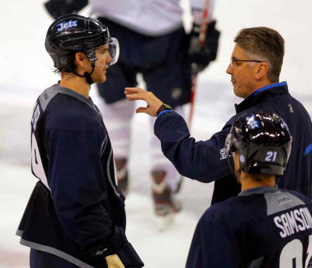 Boris Minkevich / Winnipeg Free Press
Jim Slater talks to head coach Claude Noel at a Friday workout. Slater was none too pleased with Thursday's performance against the Wild.