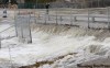 JOE BRYKSA/WINNIPEG FREE PRESS
Residents watch as floodwater gushes over the Ness Avenue bridge over the Sturgeon Creek in Winnipeg's Crestview neighborhood on Thursday. The swollen creek has forced bridges to close at Ness and Saskatchewan avenues.