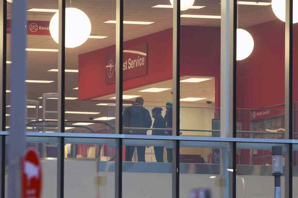JOE BRYKSA / WINNIPEG FREE PRESS
Employees chat inside the new Target store on St. James Street Thursday morning just before it opens for the day. But earlier today, Target's corporate office announced it is closing all stores in Canada.