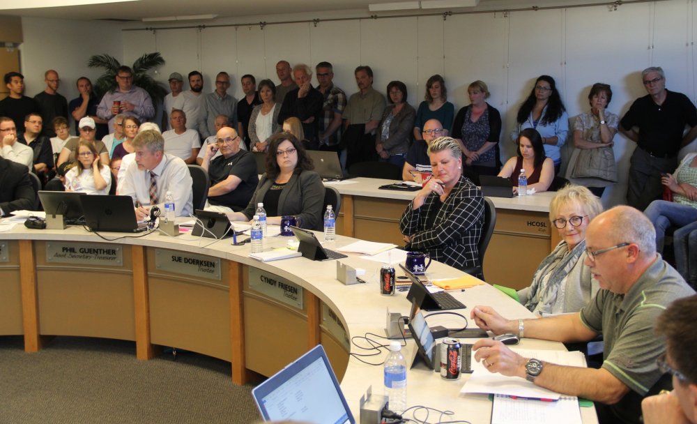 IAN FROESE / THE CARILLON
Trustee Rick Peters (bottom right) speaks as a packed house takes in the Hanover School Board meeting Tuesday night. The meeting delved into the hotly contested topic of LGBT acceptance within division schools.