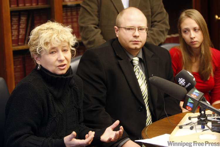 KEN GIGLIOTTI / WINNIPEG FREE PRESS
The Andrzejcak family brings a petition with 1,400 names on it calling for tougher penalties and monitoring for car thieves to the Manitoba Legislature. Pictured are Jolanta Andrzejcak with son Kamil with Kamil's wife Elizabeth.