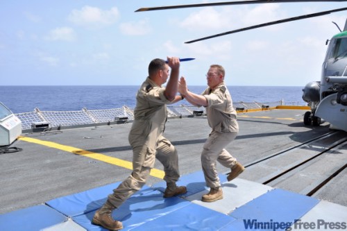 SLt Michael McWhinnie / Canadian Forces
Members of HMCS Winnipeg perform hand-to-hand combat training on the flight deck.