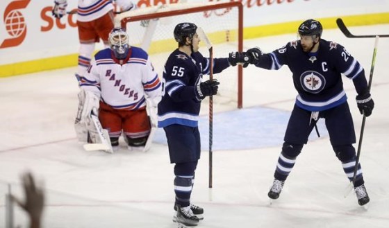 Winnipeg Jets center Mark Scheifele (55) celebrates with right wing Blake Wheeler (26) after scoring on New York Rangers goaltender Henrik Lundqvist (30) during first period NHL hockey action in Winnipeg, Tuesday, February 12, 2019. THE CANADIAN PRESS/Trevor Hagan