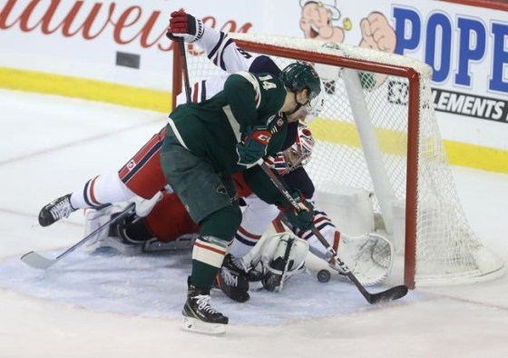 Minnesota Wild Joel Eriksson Ek (14) bangs the puck in past Winnipeg Jets' Dmitry Kulikov (5) and goaltender Connor Hellebuyck (37) late during third period NHL hockey action in Winnipeg, Tuesday, February 26, 2019. THE CANADIAN PRESS/Trevor Hagan