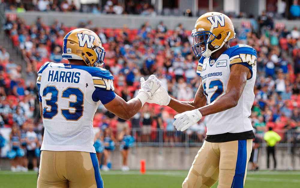 Winnipeg Blue Bombers' Andrew Harris celebrates his touchdown with teammate Adarius Bowman during first half CFL football action against the Toronto Argonauts, in Toronto on Saturday, July 21, 2018.