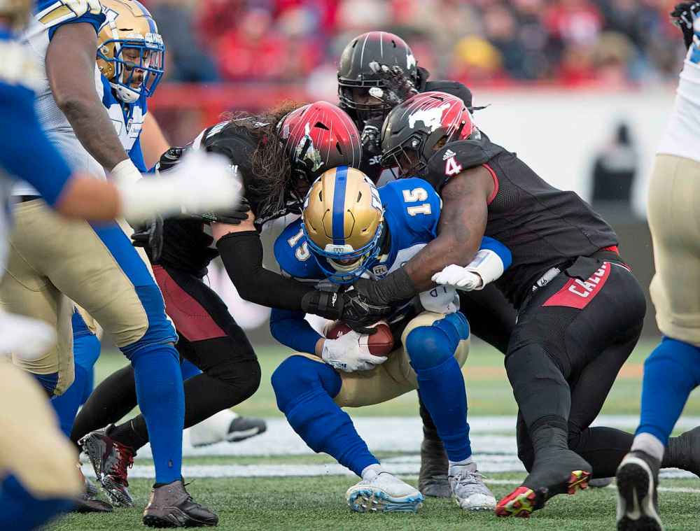 TODD KOROL / THE CANADIAN PRESS
Winnipeg Blue Bombers quarterback Matt Nichols, centre, is sacked by Calgary Stampeders during first half CFL West Final football action in Calgary, Sunday, Nov. 18, 2018.