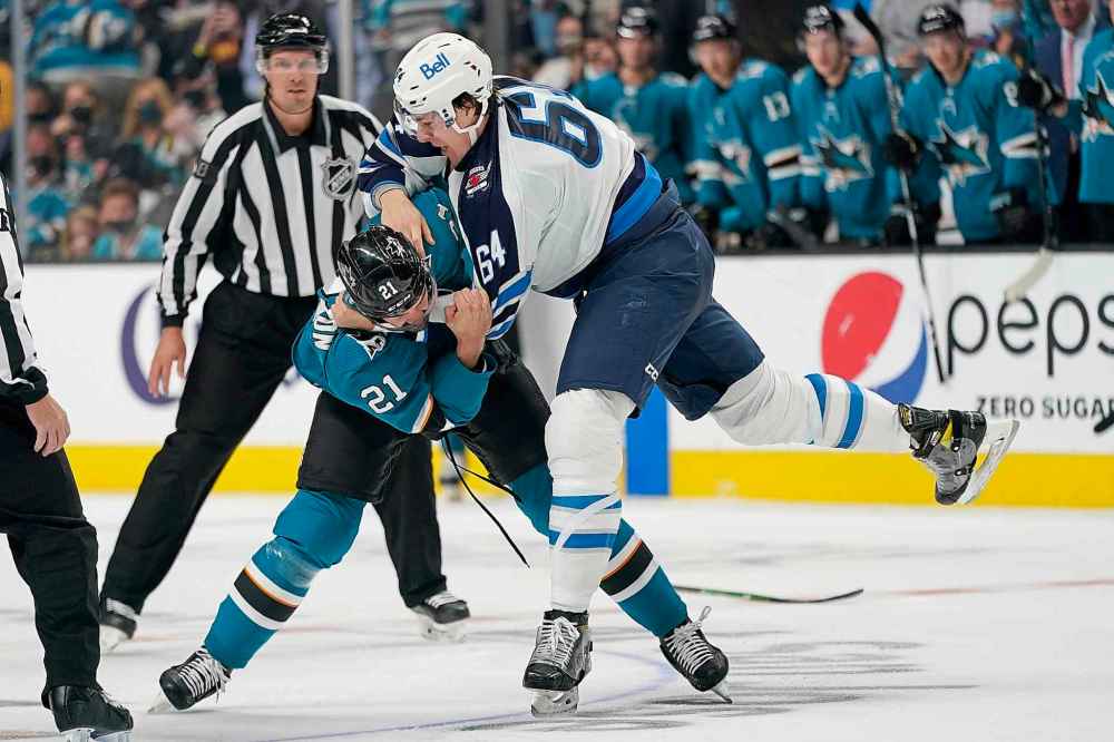 CP
San Jose Sharks defenseman Jacob Middleton (21) fights Winnipeg Jets defenseman Logan Stanley (64) during the second period. (Jeff Chiu / The Associated Press)
