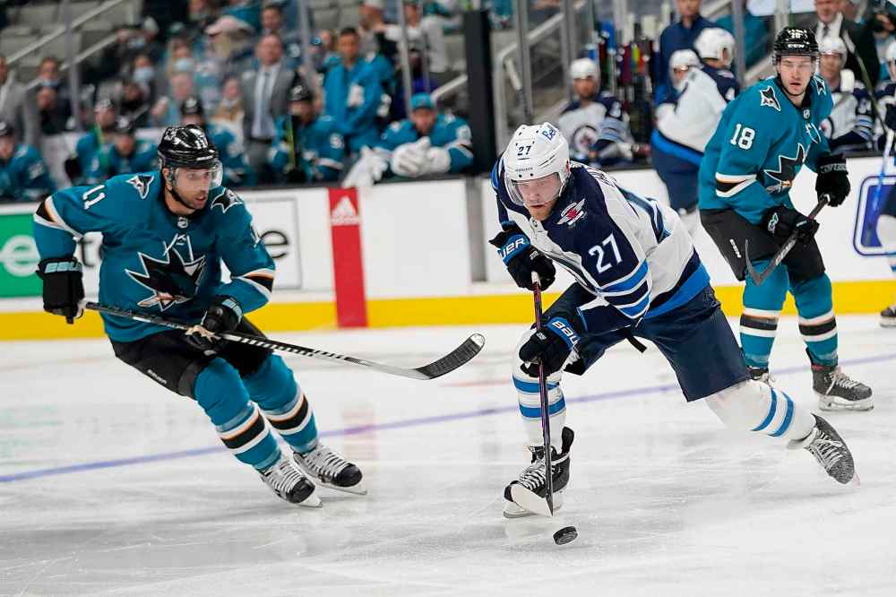 CP
Winnipeg Jets left wing Nikolaj Ehlers (27) skates with the puck against San Jose Sharks center Andrew Cogliano (11) during the second period. (Jeff Chiu / The Associated Press)
