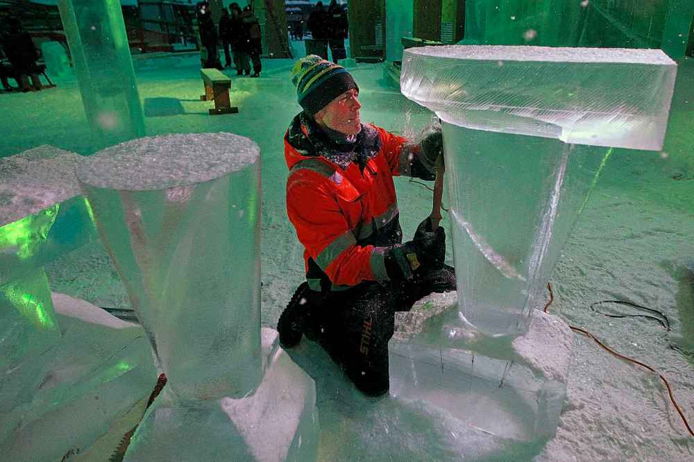 PHIL HOSSACK / WINNIPEG FREE PRESS - Luca Roncoroni puts the finishing touches on a set of luminescent bar tables at the opening night of the Ice Bar on the Red River Wednesday. Luca hails originally from Italy, now lives in Norway and makes the trip to Winnipeg every year to work on the trail's Warming Huts and features. See story. January 23, 2019