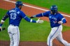 Toronto Blue Jays' Vladimir Guerrero Jr., right, is congratulated by Lourdes Gurriel Jr. after hitting a solo home run against the New York Yankees during the second inning of a baseball game in Buffalo, N.Y., Thursday, Sept. 24, 2020. (AP Photo/Adrian Kraus)