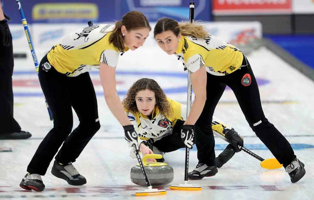 Team Manitoba's third Karlee Burgess and second Emily Zacharias sweep for skip Mackenzie Zacharias while playing against Team Alberta. (TREVOR HAGAN / WINNIPEG FREE PRESS)