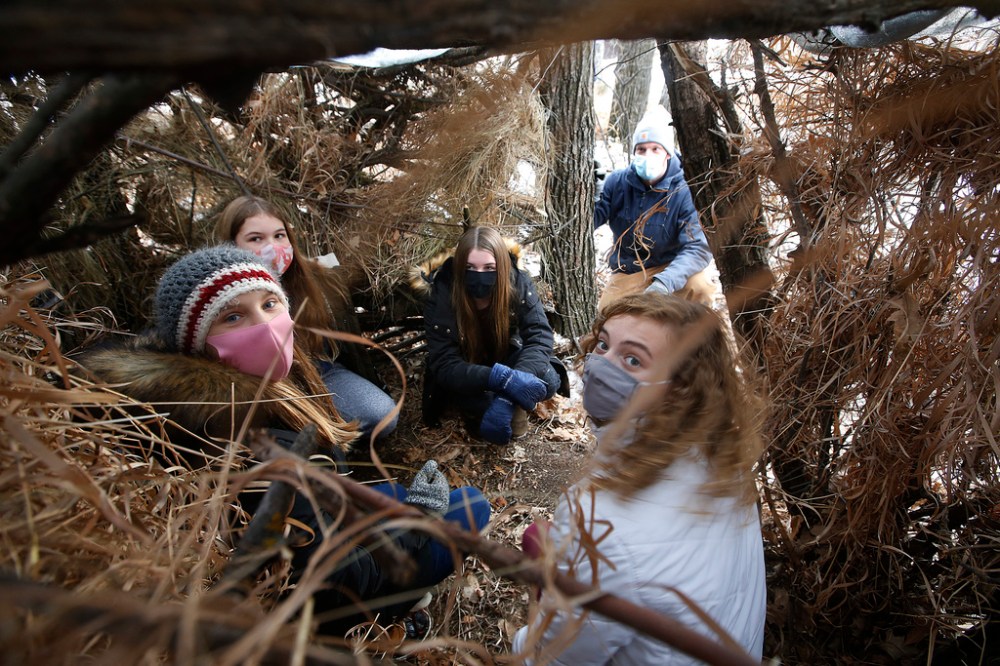 JOHN WOODS / WINNIPEG FREE PRESS
Starbuck School students Anjali Smelski Zuk (from left), Myriam Duval, Isabel Fischer and Kiera Mosset in their survival shelter Thursday with their teacher Tim Morrison in the background. (John Woods / Winnipeg Free Press)