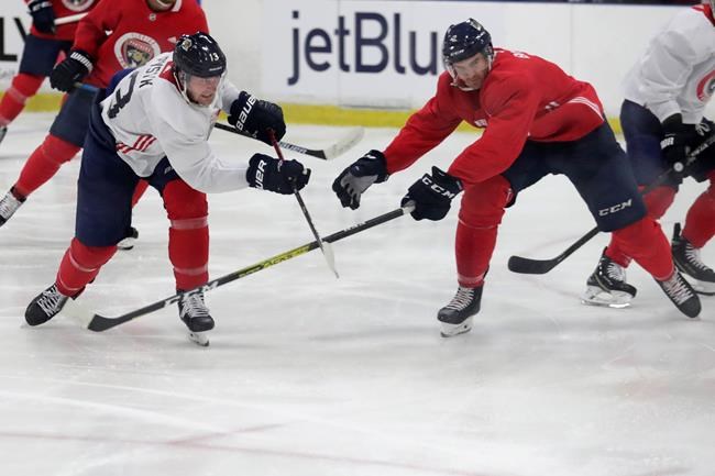 Florida Panthers' Mark Pysyk, left, passes the puck as Josh Brown, right, defends during NHL hockey training practice Friday, July 17, 2020, in Coral Springs, Fla. THE CANADIAN PRESS/AP/Lynne Sladky