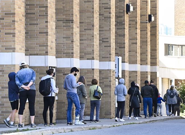 People line up at a COVID assessment centre during the COVID-19 pandemic in Toronto on Friday, September 18, 2020. THE CANADIAN PRESS/Nathan Denette