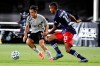 Montreal Impact's Bojan, left, makes a move to get past New England Revolution's Michael Mancienne (13) during the second half of an MLS soccer match in Kissimmee, Fla., on July 9, 2020. THE CANADIAN PRESS/AP-John Raoux
