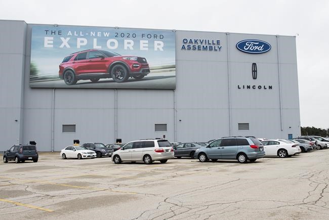A parking lot with employees vehicles at the Ford assembly plant in Oakville, Ont., on Thursday, March 19, 2020. The federal and Ontario governments are each chipping in more than $250 million to mass produce electric vehicles — and the batteries that power them — at Ford Motor Co.'s plant in Oakville, Ontario. THE CANADIAN PRESS/Nathan Denette