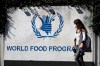 A woman walks past a sign at the entrance of the United Nations World Food Program (WFP), in Rome, Friday, Oct. 9, 2020. THE CANADIAN PRESS/AP/Gregorio Borgia